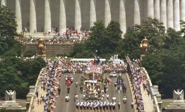 FILE - This view, taken from Arlington National Cemetery, shows troops marching across the Memorial Bridge, with the Lincoln Memorial in the background, in Washington, heading towards the Pentagon during the National Victory Day Parade, June 8, 1991. The celebration to honor Gulf War troops drew an estimated 800,000 spectators. (AP Photo/Greg Gibson, File)