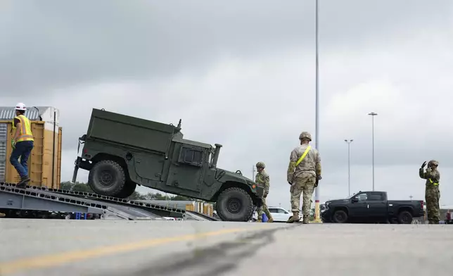 U.S. Army personnel offload tanks and other military vehicles, Monday, June 9, 2025, at the CSX railroad yard in Jessup, Md., ahead of an upcoming military parade commemorating the U.S. Army’s 250th anniversary and coinciding with Donald Trump’s 79th birthday. (AP Photo/Stephanie Scarbrough)