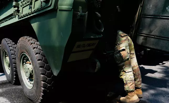 A U.S. Army soldier works on a Stryker combat vehicle staged in West Potomac Park ahead of an upcoming military parade commemorating the Army's 250th anniversary and coinciding with Donald Trump's 79th birthday, Wednesday, June 11, 2025, in Washington (AP Photo/Julia Demaree Nikhinson)