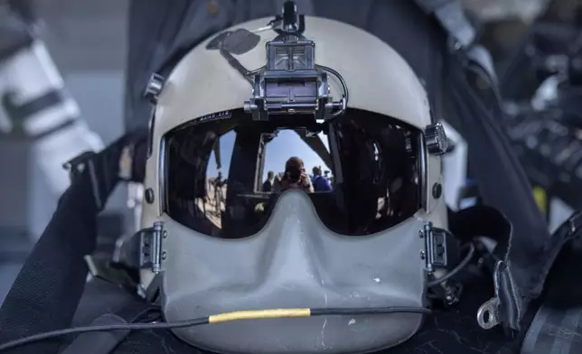 A flight helmet rests on a seat in a U.S. Army UH-60M Black Hawk helicopter that will participate in an upcoming military parade commemorating the Army's 250th anniversary and coinciding with President Donald Trump's 79th birthday, at Joint Base Andrews, Md., Thursday, June 12, 2025. (AP Photo/Mark Schiefelbein)
