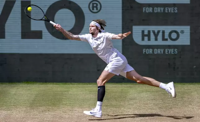 Kazakhstan's Alexander Bublik returns the ball to Russia's Daniil Medvedev during their men's single final of the Halle tennis tournament, Germany, Sunday, June 22, 2025. (David Inderlied/dpa via AP)