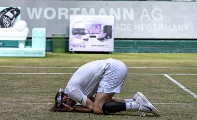 Kazakhstan's Alexander Bublik reacts after defeating Russia's Daniil Medvedev in their men's single final of the Halle tennis tournament, Germany, Sunday, June 22, 2025. (David Inderlied/dpa via AP)