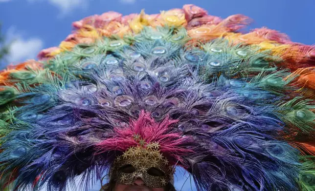 A person wearing a mask is pictured before the World Pride parade, Saturday, June 7, 2025, in Washington. (AP Photo/Julia Demaree Nikhinson)