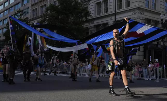 People march during the World Pride Parade, Saturday, June 7, 2025, in Washington. (AP Photo/Mark Schiefelbein)