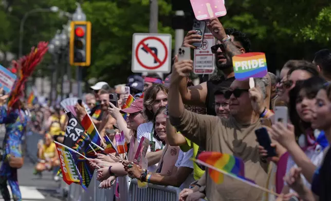 People attend the World Pride parade, Saturday, June 7, 2025, in Washington. (AP Photo/Mark Schiefelbein)
