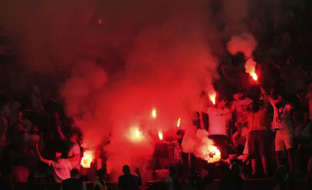 PSG fans celebrate after Desire Doue scored his side's second goal during the Champions League final soccer match between Paris Saint-Germain and Inter Milan at the Allianz Arena in Munich, Germany, Saturday, May 31, 2025. (AP Photo/Luca Bruno)
