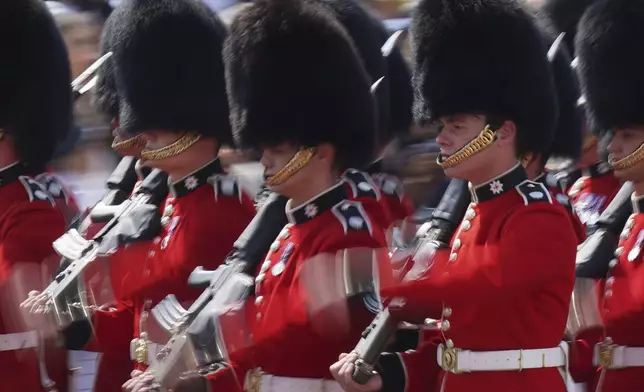 Soldiers from the Coldstream Guards march along the Mall as they take part in the Trooping the Color in London, Saturday, June 14, 2025. (AP Photo/Alberto Pezzali)