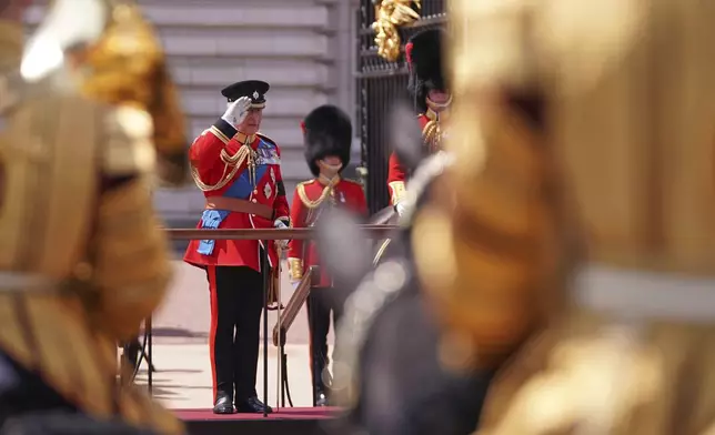 Britain's King Charles salutes troops as they match past during the Trooping the Colour in London, Saturday, June 14, 2025. (AP Photo/Alberto Pezzali)