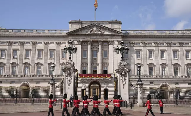Members of the Foot Guards march outside Buckingham Palace ahead of Trooping the Colour ceremony, the king's annual birthday parade, in London, Saturday, June 14, 2025. (Aaron Chown/PA via AP)