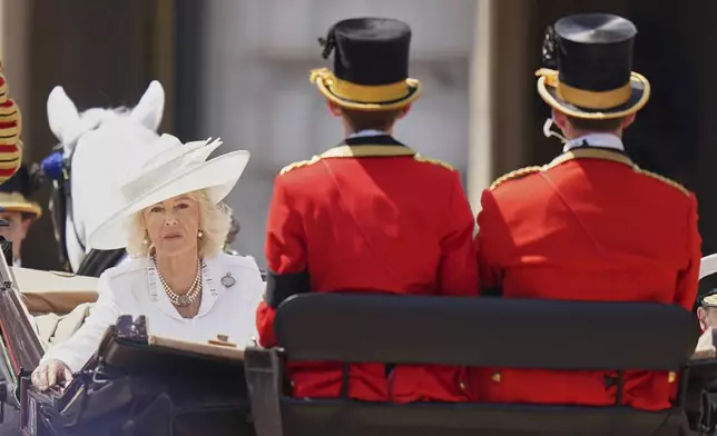 Britain's Queen Camilla rides in a carriage as she take part in the Trooping the Colour in London, Saturday, June 14, 2025. (AP Photo/Alberto Pezzali)