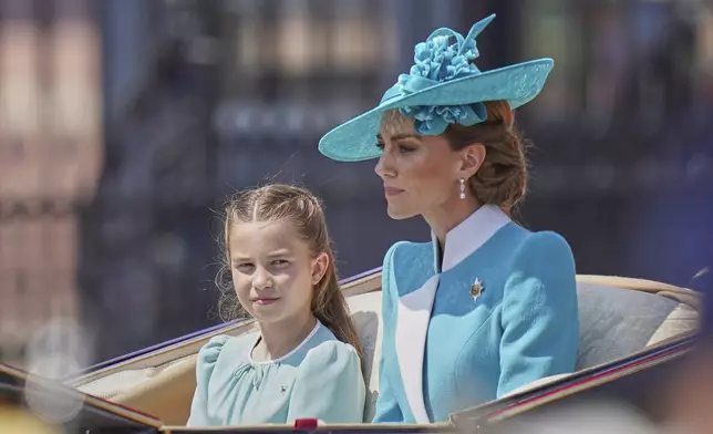 Kate, Princess of Wales with her daughter Princess Charlotte ride in a carriage as they take part in the Trooping the Colour in London, Saturday, June 14, 2025. (AP Photo/Alberto Pezzali)