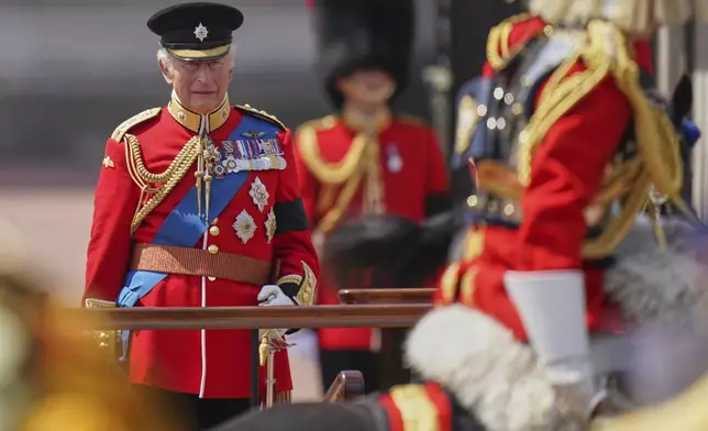 Britain's King Charles looks at troops as they match past during the Trooping the Colour in London, Saturday, June 14, 2025, the king is wearing a black armband as a mark of respect to the victims of the Air India plane crash. (AP Photo/Alberto Pezzali)