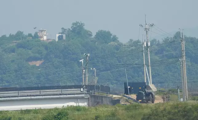 A North Korean military guard post, loudspeaker, top left, and South Korean army soldiers, bottom right, are seen from Paju, South Korea, near the border with North Korea, Thursday, June 12, 2025. (AP Photo/Ahn Young-joon)
