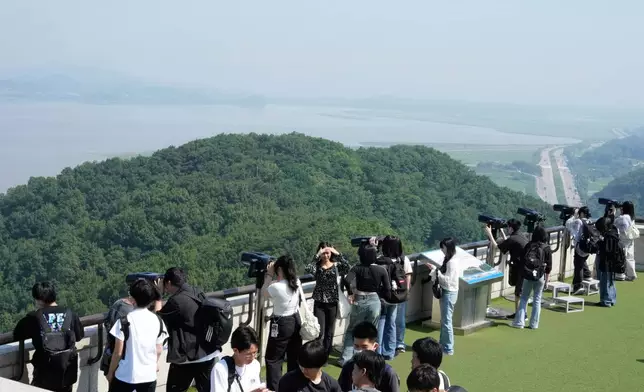 Visitors watch the North Korea side from the unification observatory in Paju, South Korea, near the border with North Korea, Thursday, June 12, 2025. (AP Photo/Ahn Young-joon)
