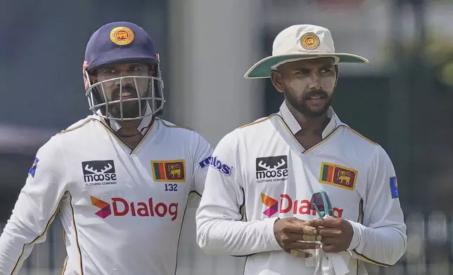 Sri Lanka's Sonal Dinusha, right, is congratulated by Kusal Mendis for taking the wicket of Bangladesh's Taijul Islam during the second day of the second cricket test match between Sri Lanka and Bangladesh in Colombo, Sri Lanka, Thursday, June 26, 2025. (AP Photo/Eranga Jayawardena)