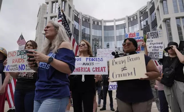 Protesters gather outside the Federal Courthouse before arguments about whether Kilmar Abrego Garcia can be released from jail on Friday, June 13, 2025 in Nashville, Tenn. (AP Photo/George Walker IV)