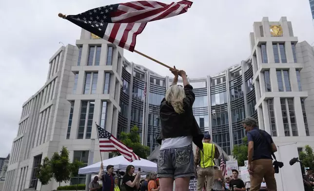 Protesters gather outside the Federal Courthouse before arguments about whether Kilmar Abrego Garcia can be released from jail on Friday, June 13, 2025 in Nashville, Tenn. (AP Photo/George Walker IV)