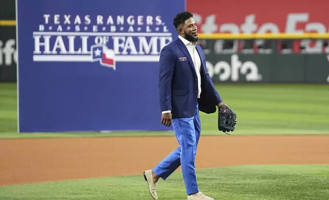 Former Texas Rangers player Elvis Andrus walks across the field during a ceremony where Andrus was inducted into the clubs hall of fame before a baseball game against the Seattle Mariners Saturday, June 28, 2025, in Arlington, Texas. (AP Photo/Tony Gutierrez)