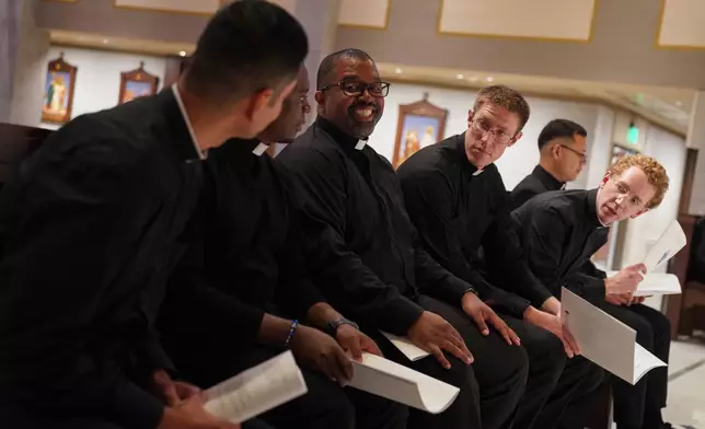 From left, the Rev. Alfredo Tuesta, the Rev. Christian Njodzela, the Rev. Ricky Malebranche, the Rev. Raymond Goins, the Rev. Jordan Evans, and the Rev. Emmanuel Carreno Garcia, attend rehearsal for their ordination Mass at the Cathedral of Saint Thomas More in Arlington, Va., on Friday, June 6, 2025. (AP Photo/Jessie Wardarski)