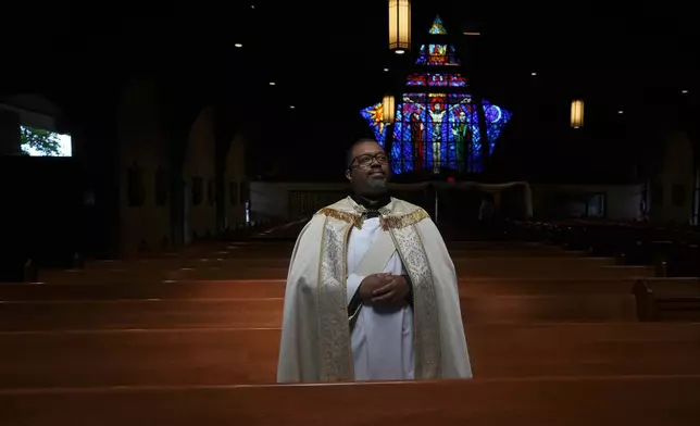 The Rev. Ricky Malebranche poses for a portrait after baptizing a child at St. Louis Catholic Church in Gainesville, Va., on Saturday, May 24, 2025. (AP Photo/Luis Andres Henao)