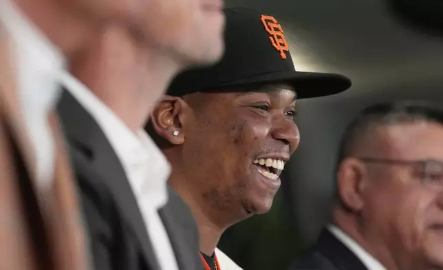 San Francisco Giants' Rafael Devers smiles while speaking at a news conference before a baseball game against the Cleveland Guardians in San Francisco, Tuesday, June 17, 2025. (AP Photo/Jeff Chiu)