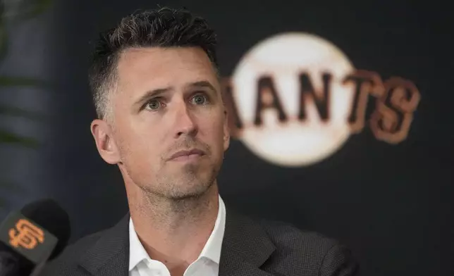 San Francisco Giants President of Baseball Operations Buster Posey listens at a news conference before a baseball game between the Giants and the Cleveland Guardians in San Francisco, Tuesday, June 17, 2025. (AP Photo/Jeff Chiu)