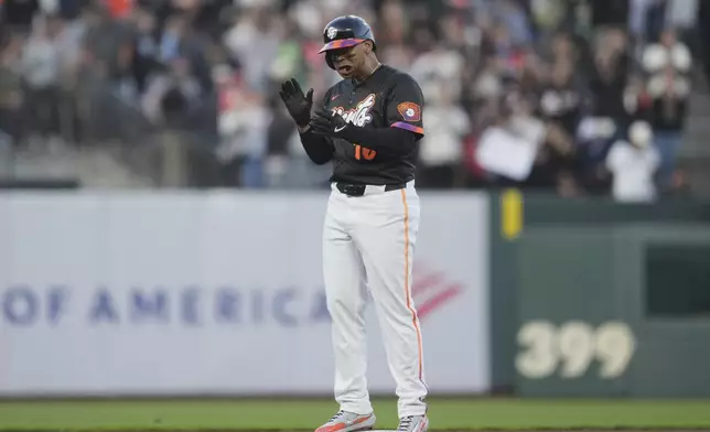 San Francisco Giants' Rafael Devers reacts after hitting an RBI double against the Cleveland Guardians during the third inning of a baseball game in San Francisco, Tuesday, June 17, 2025. (AP Photo/Jeff Chiu)