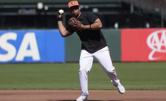 San Francisco Giants' Rafael Devers warms up before a baseball game against the Cleveland Guardians in San Francisco, Tuesday, June 17, 2025. (AP Photo/Jeff Chiu)