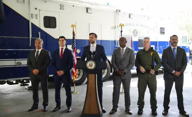 Vice President JD Vance, center, speaks next to officials including, from left to right, HUD Regional Administrator William Spencer, United States Attorney for the Central District of California Bill Essayli, FBI Los Angeles Assistant Director Akil Davis, US Border Patrol Sector Chief Gregory Bovino and ICE Field Office Director Ernie Santacruz at the Wilshire Federal Building Friday, June 20, 2025, in Los Angeles. (AP Photo/Jae C. Hong)