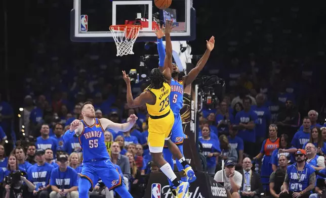 Indiana Pacers forward Aaron Nesmith (23) shoots against Oklahoma City Thunder guard Luguentz Dort (5) during the first half of Game 2 of the NBA Finals basketball series Sunday, June 8, 2025, in Oklahoma City. (AP Photo/Julio Cortez)