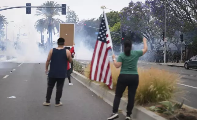 Protesters confront Border Patrol personnel during a demonstration over the dozens detained in an operation by federal immigration authorities a day earlier in Paramount section of Los Angeles Saturday, June 7, 2025. (AP Photo/Eric Thayer)