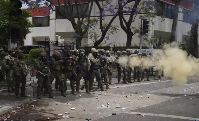 Border Patrol personnel deploy tear gas during a demonstration over the dozens detained in an operation by federal immigration authorities a day earlier in Paramount section of Los Angeles Saturday, June 7, 2025. (AP Photo/Eric Thayer)