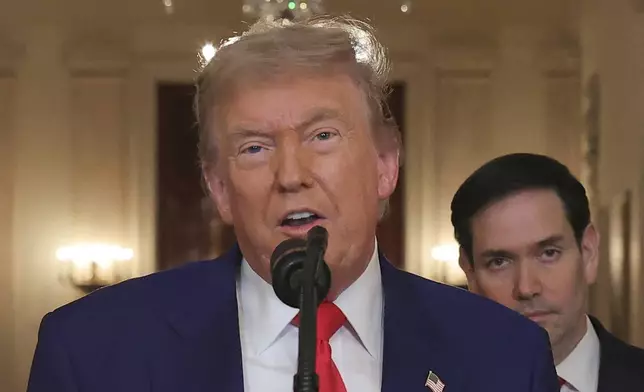 President Donald Trump speaks from the East Room of the White House in Washington, Saturday, June 21, 2025, after the U.S. military struck three Iranian nuclear and military sites, directly joining Israel's effort to decapitate the country's nuclear program, as Secretary of State Marco Rubio listens. (Carlos Barria/Pool via AP)