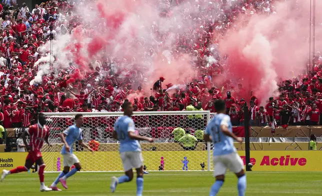 Wydad's supporters light torches during the Club World Cup group G soccer match between Manchester City and Wydad AC in Philadelphia, Wednesday, June 18, 2025. (AP Photo/Derik Hamilton)