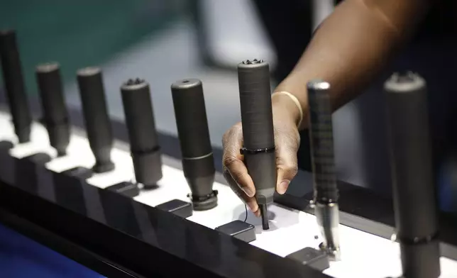 FILE- Gun silencers are on display at the Sig Sauer booth at the Shooting, Hunting and Outdoor Trade Show in Las Vegas, Jan. 19, 2016. (AP Photo/John Locher, File)