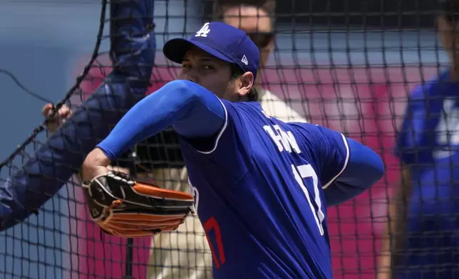 Los Angeles Dodgers' pitcher Shohei Ohtani throws to a live batter prior to a baseball game against the New York Yankees, Saturday, May 31, 2025, in Los Angeles. (AP Photo/Mark J. Terrill)