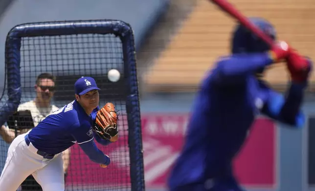 Los Angeles Dodgers' pitcher Shohei Ohtani throws to a live batter prior to a baseball game against the New York Yankees, Saturday, May 31, 2025, in Los Angeles. (AP Photo/Mark J. Terrill)