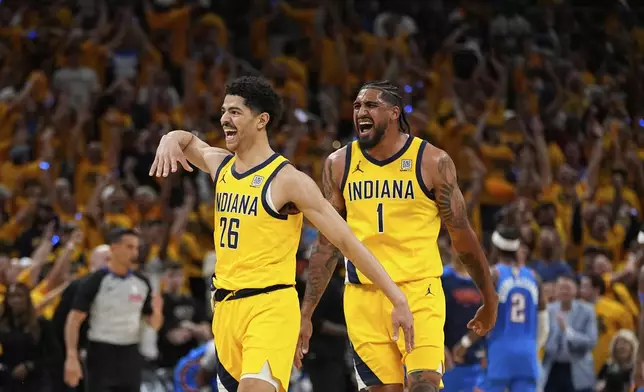 Indiana Pacers guard Ben Sheppard (26) and forward Obi Toppin (1) celebrate during the second half of Game 6 of the NBA Finals basketball series against the Oklahoma City Thunder, Thursday, June 19, 2025, in Indianapolis. (AP Photo/Abbie Parr)