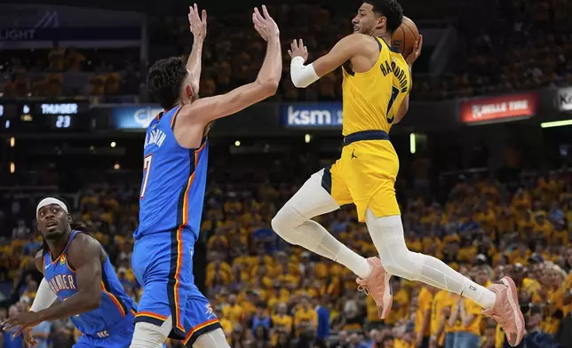 Indiana Pacers guard Tyrese Haliburton, right, passes over Oklahoma City Thunder forward Chet Holmgren (7) during the first half of Game 6 of the NBA Finals basketball series, Thursday, June 19, 2025, in Indianapolis. (AP Photo/Abbie Parr)