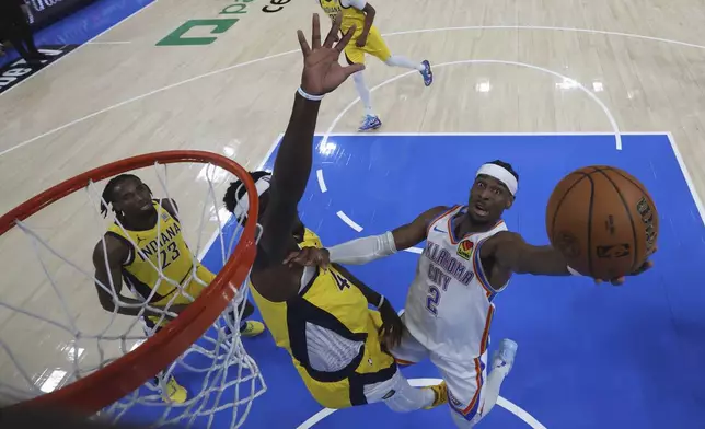 Oklahoma City Thunder guard Shai Gilgeous-Alexander (2) shoots around Indiana Pacers forward Pascal Siakam during the second half of Game 5 of the NBA Finals basketball series, Monday, June 16, 2025, in Indianapolis. (Matthew Stockman/Pool Photo via AP)