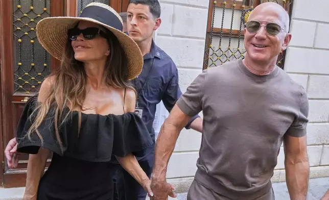 Lauren Sanchez Bezos and Jeff Bezos leave Harry's Bar in Venice, Italy, Saturday, June 28, 2025, the day after their wedding. (AP Photo/Luca Bruno)