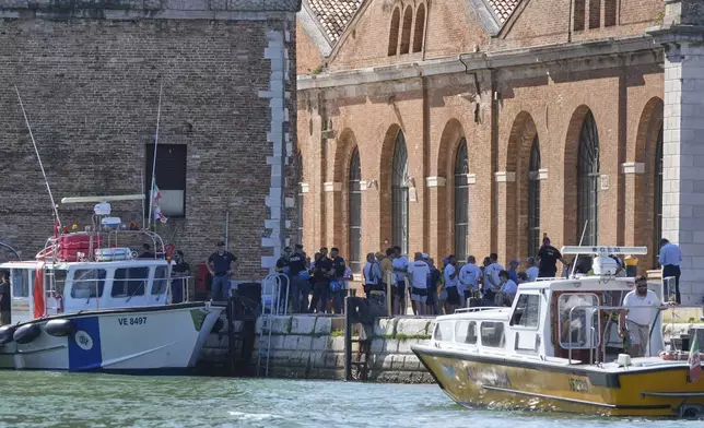 Security gather in front of the Venice Arsenale in Venice, Italy, Saturday, June 28, 2025. (AP Photo/Luca Bruno)