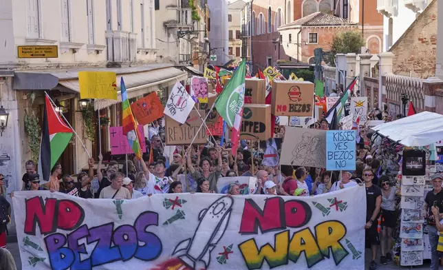Activists stage a protest in Venice, Italy, Saturday, June 28, 2025, denouncing the three-day celebrations for the wedding between Jeff Bezos and his wife Lauren Sanchez Bezos that took place in Venice on Friday as a symbol of rising inequality and disregard for the city's residents. (AP Photo/Antonio Calanni)