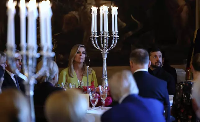 Netherland's Queen Maxima, center left, and Ukraine's President Volodymyr Zelenskyy, right, attend a dinner of NATO heads of state and government at the Paleis Huis ten Bosch ahead of the NATO summit in The Hague, Netherlands, Tuesday, June 24, 2025. (Remko de Waal, Pool Photo via AP)