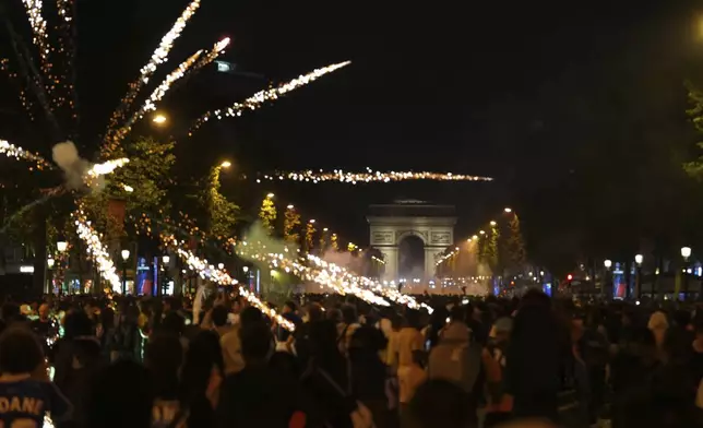 Fireworks explode on the Champs-Elysees avenue after the Champions League final soccer match between Paris Saint-Germain and Inter Milan, Sunday, June 1, 2025 in Paris. (AP Photo/Aurelien Morissard)