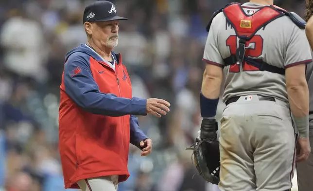 Atlanta Braves' Brian Snitker makes a pitching change during the sixth inning of a baseball game against the Milwaukee Brewers, Tuesday, June 10, 2025, in Milwaukee. (AP Photo/Aaron Gash)