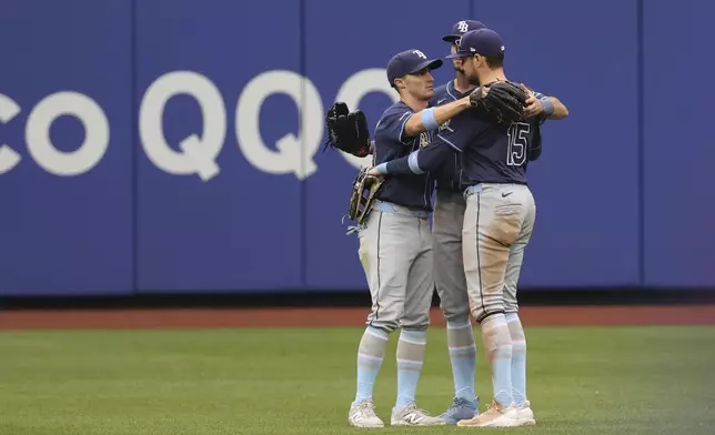 Tampa Bay Rays outfielders Jake Mangum, left, Kameron Misner, center, and Josh Lowe, right, react after defeating the New York Mets in a baseball game Sunday, June 15, 2025, in New York. (AP Photo/Pamela Smith)