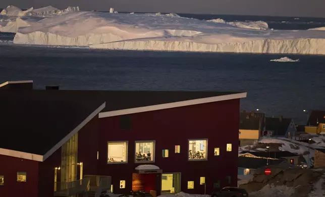FILE - Public school pupils are seen inside their classrooms next to the large icebergs in Ilulissat, Greenland, Feb. 19, 2025. (AP Photo/Emilio Morenatti, File)