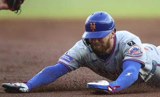 New York Mets' Brandon Nimmo steals third base in the third inning of a baseball game against the Atlanta Braves, Thursday, June 19, 2025, in Atlanta. (AP Photo/Colin Hubbard)