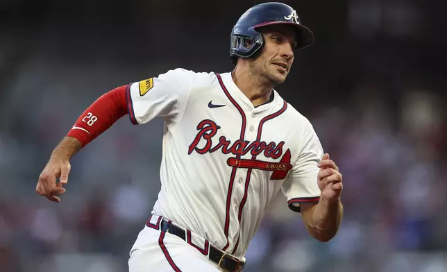 Atlanta Braves' Matt Olson rounds third base before scoring a run in the fourth inning of a baseball game against the New York Mets, Thursday, June 19, 2025, in Atlanta. (AP Photo/Colin Hubbard)